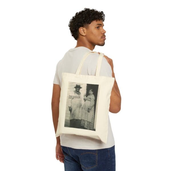 Man carrying a tote bag with a photo of a couple.