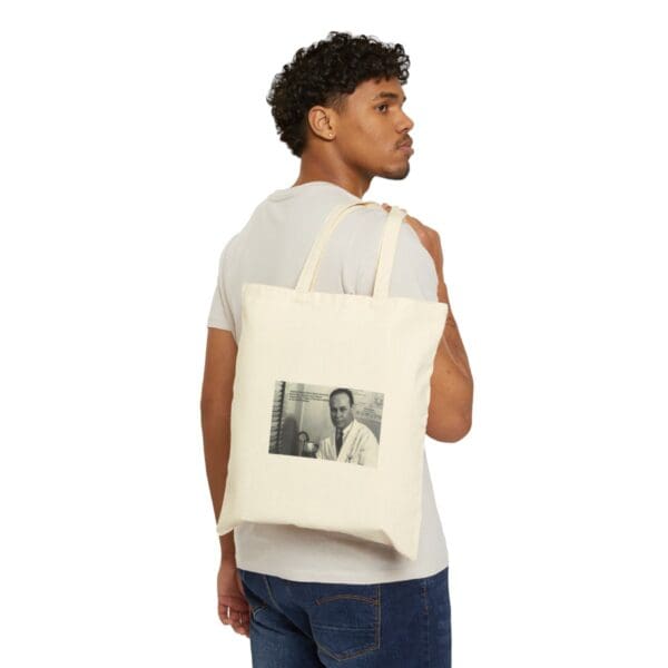 Man carrying a tote bag with a picture of a man.