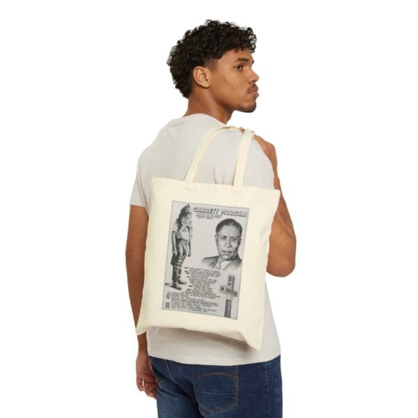 Man carrying a Garrett Morgan tote bag.