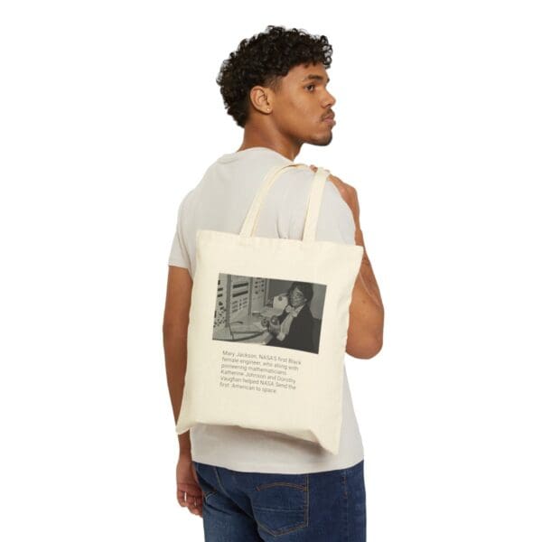 Man carrying tote bag with Mary Jackson image.