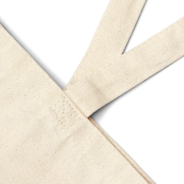 Beige canvas tote bag handle detail.