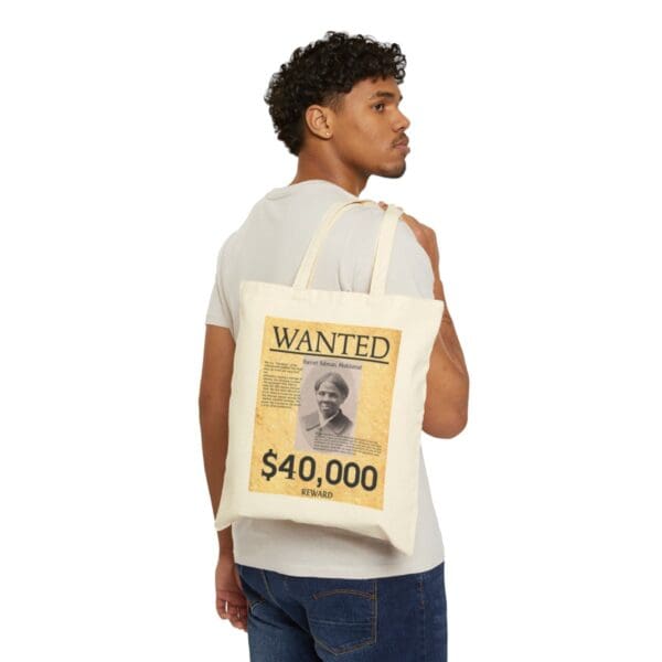 Man carrying a tote bag with a Harriet Tubman wanted poster.