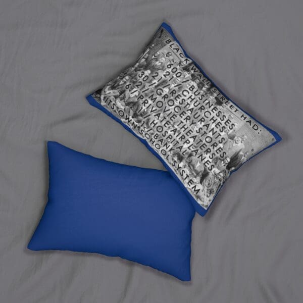 Two pillows, one with text about Black Wall Street.