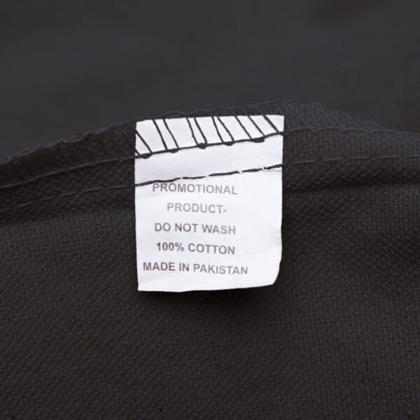 Black fabric with a white care tag.