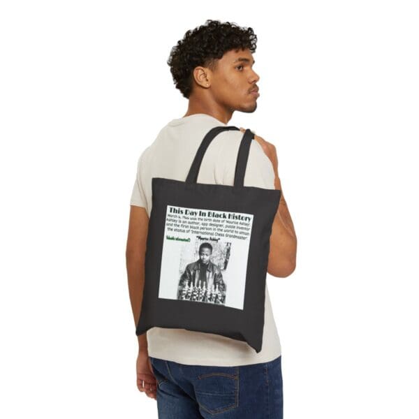 Man carrying black tote bag with Black History quote.