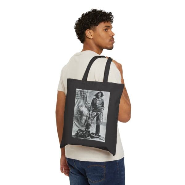 Man wearing a black tote bag with a cowboy image.