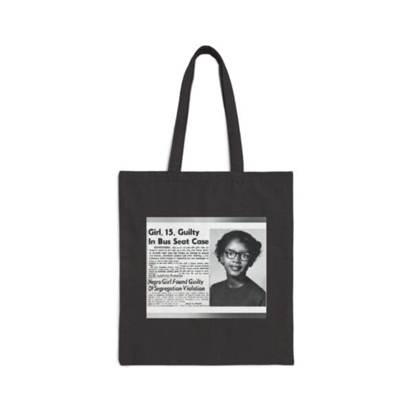 Black tote bag with a newspaper clipping.