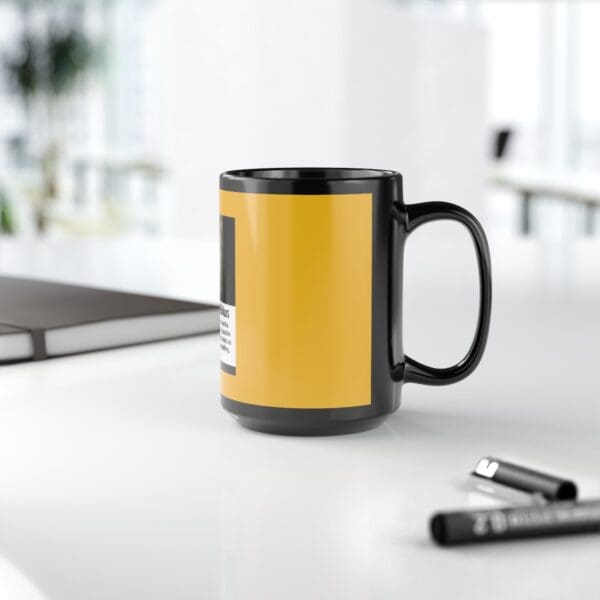 Black mug with yellow text and design.