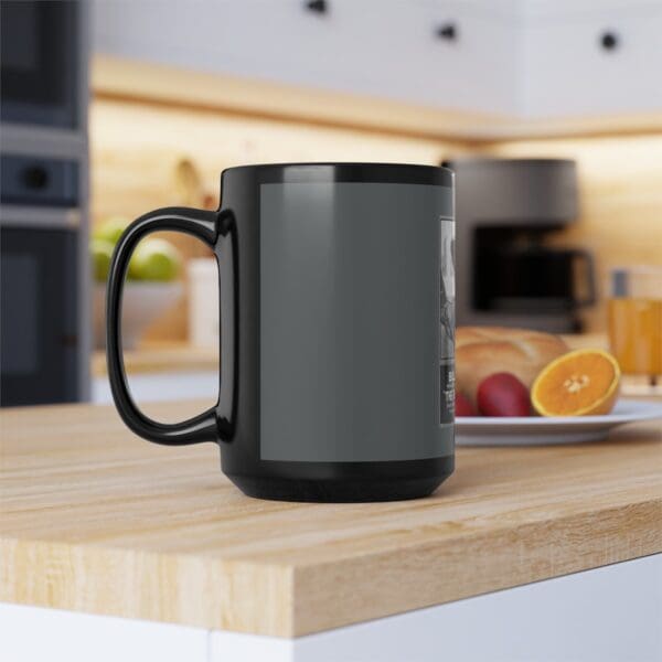 Black coffee mug with a design on it.