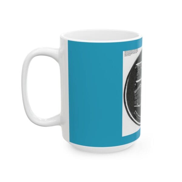 White mug with a blue design and a coin