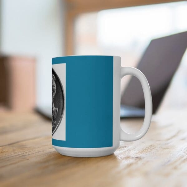 White mug with a coin design on a blue background.