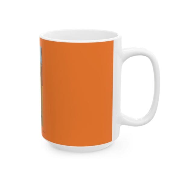 White coffee mug with orange design.