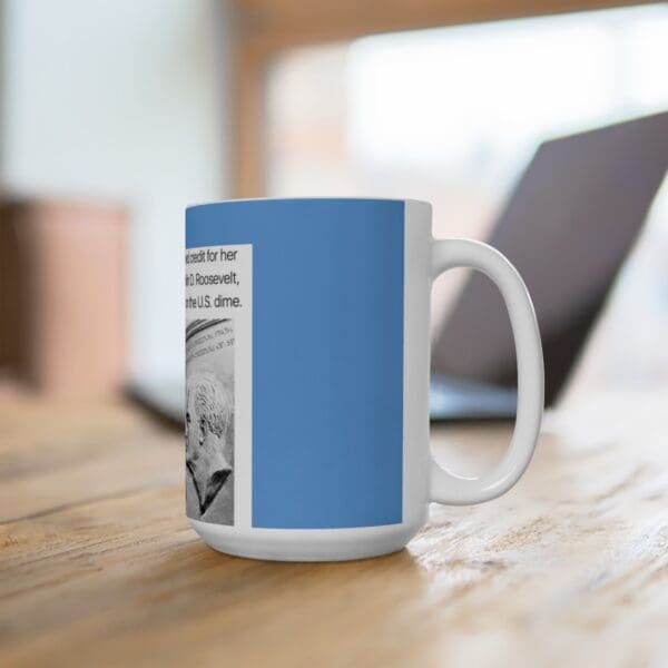 White coffee mug with blue design and US dime.