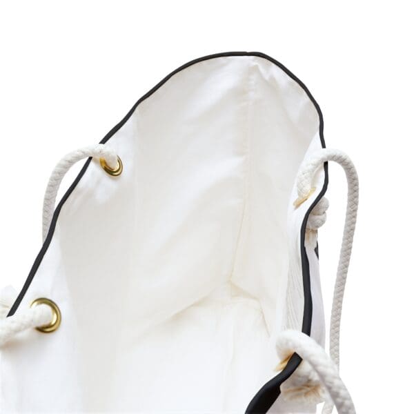 White canvas tote bag with black trim.