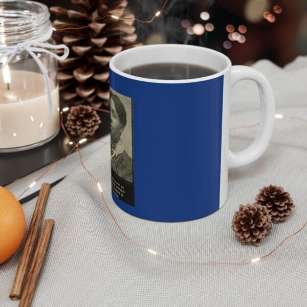 Blue coffee mug with a woman's portrait.