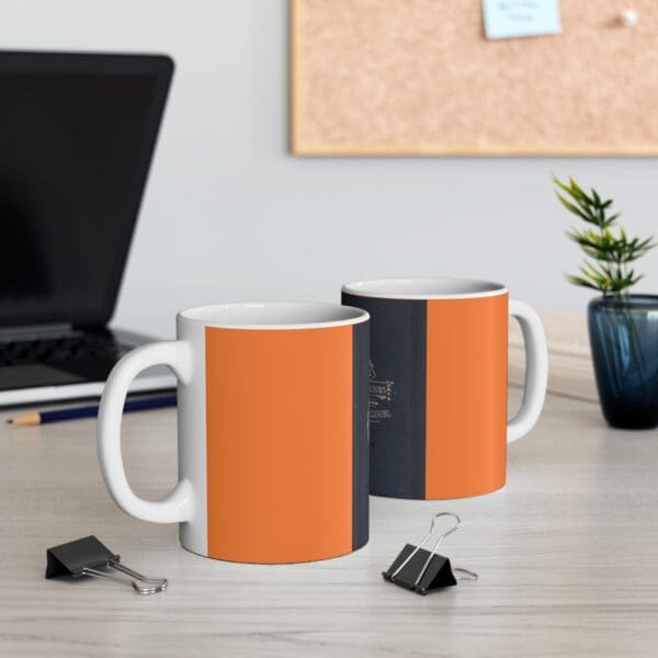 Two orange and black coffee mugs.