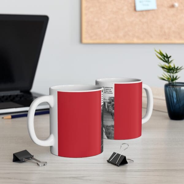 Red and white coffee mug on table.