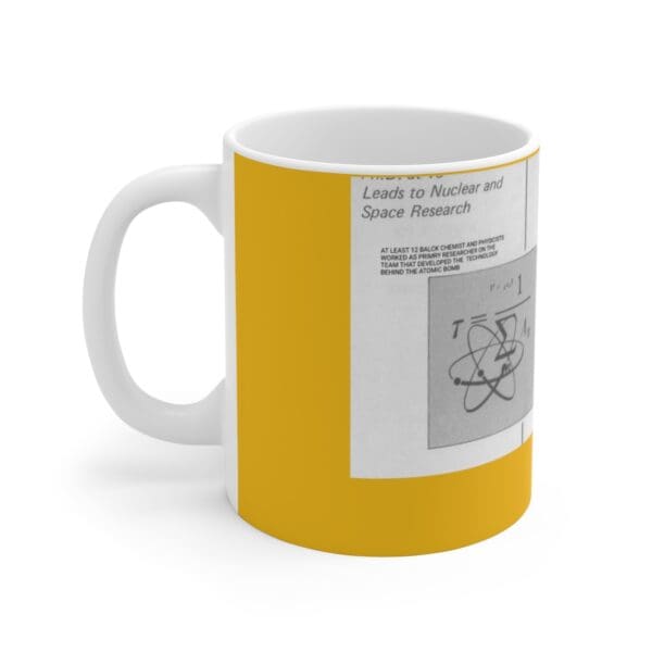 White mug with yellow and nuclear atom graphic.