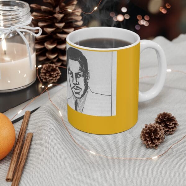 Yellow mug with a man's portrait.