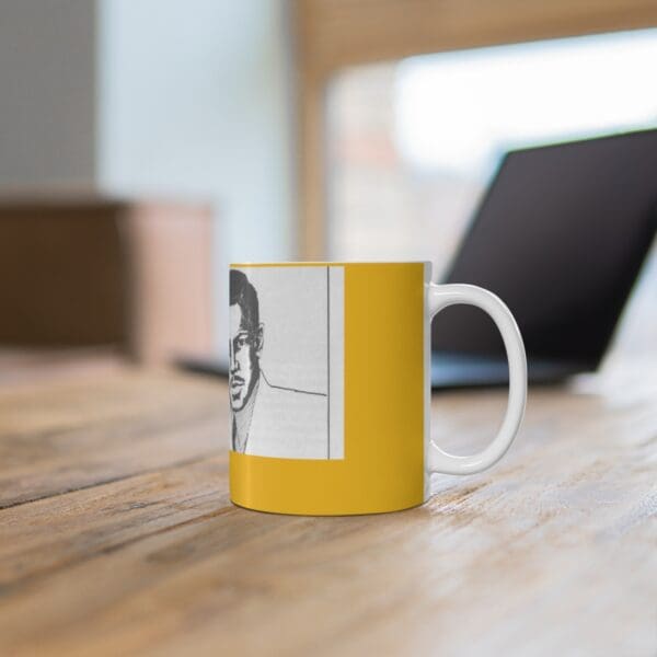 Yellow mug with a man's face on it.