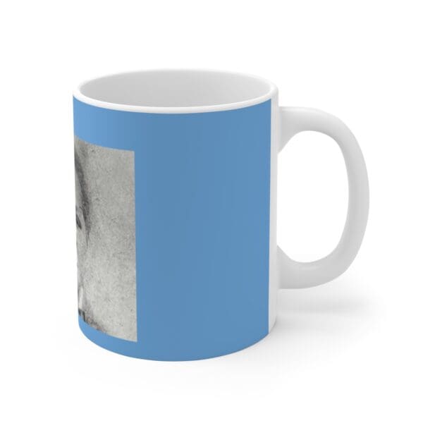 White mug with a blue background and a portrait.