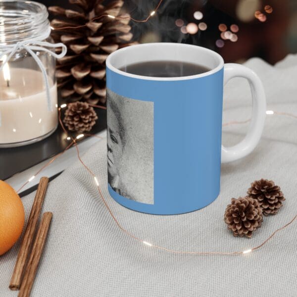 Blue mug with a black and white portrait.