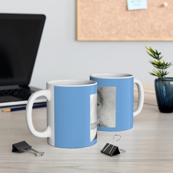 Two blue mugs with a portrait.