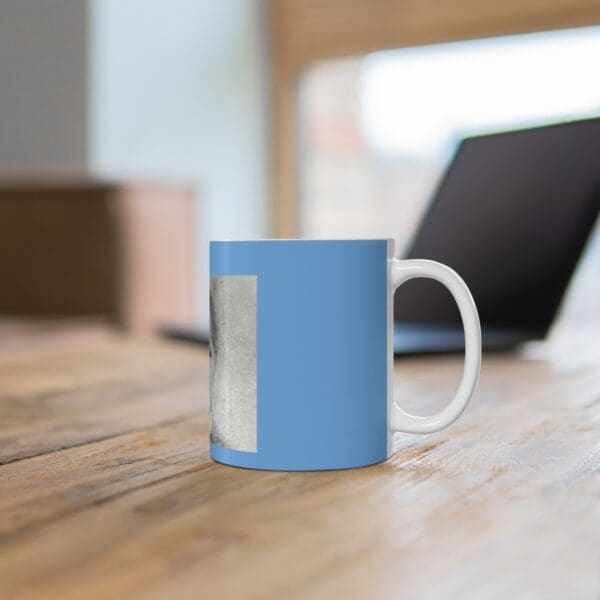 Blue mug with black and white image.