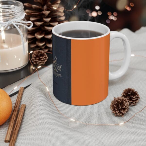 Orange and black mug with hot coffee.