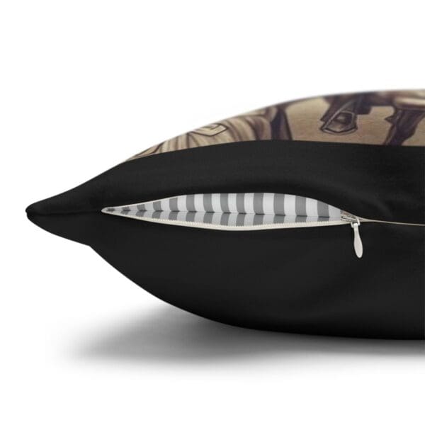 Black pillow with zipper closure.