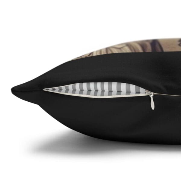 Black pillow with zipper and stripes.