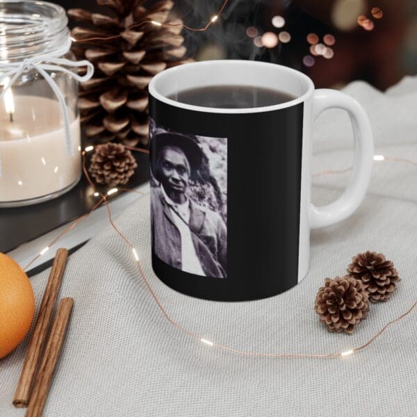 Black mug with a man's portrait.