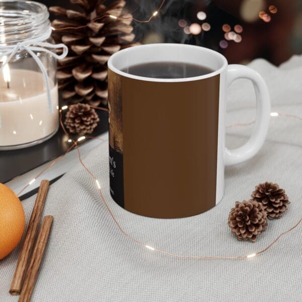 A white coffee mug with brown design.