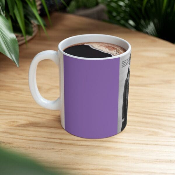 Purple mug with coffee and a photo.