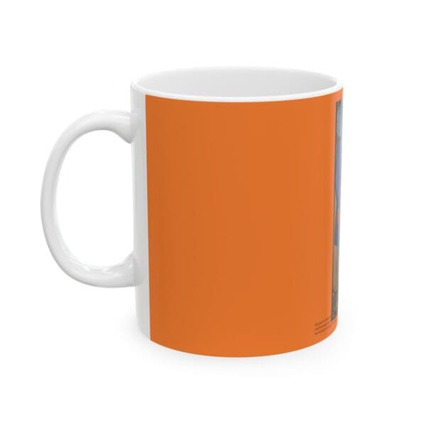 Orange mug with a painting on it.