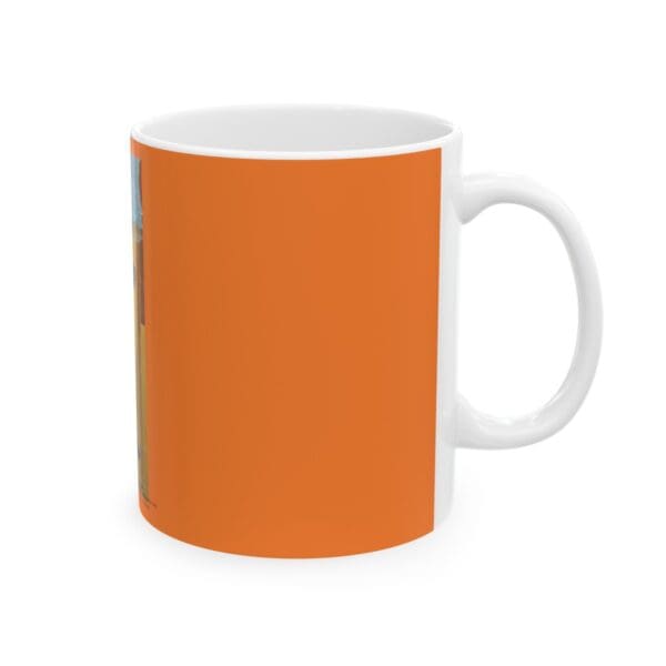 White coffee mug with orange design.