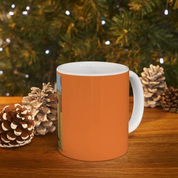 Orange mug with a colorful design.