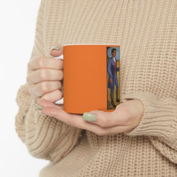 Person holding a mug with a painting.