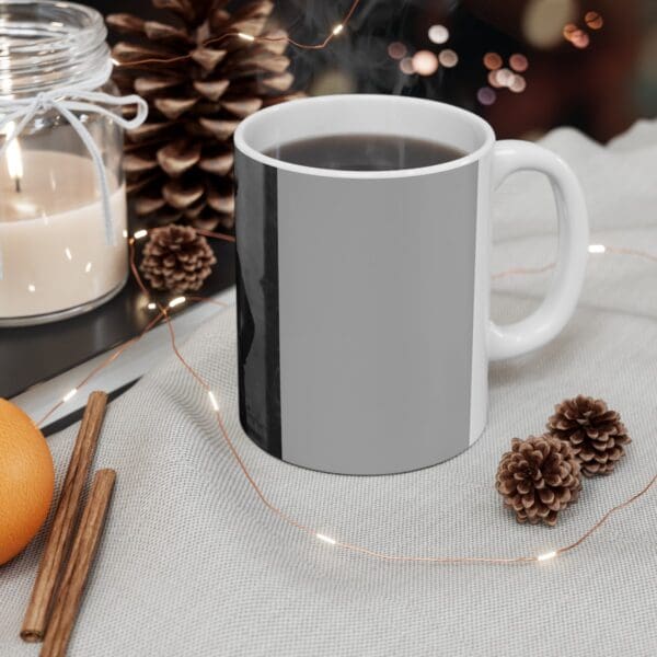 White mug with coffee and pine cones.