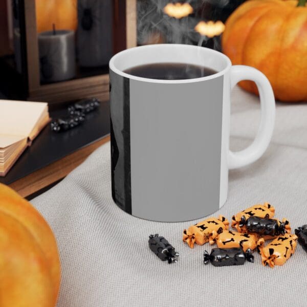 White mug with coffee and Halloween candy.