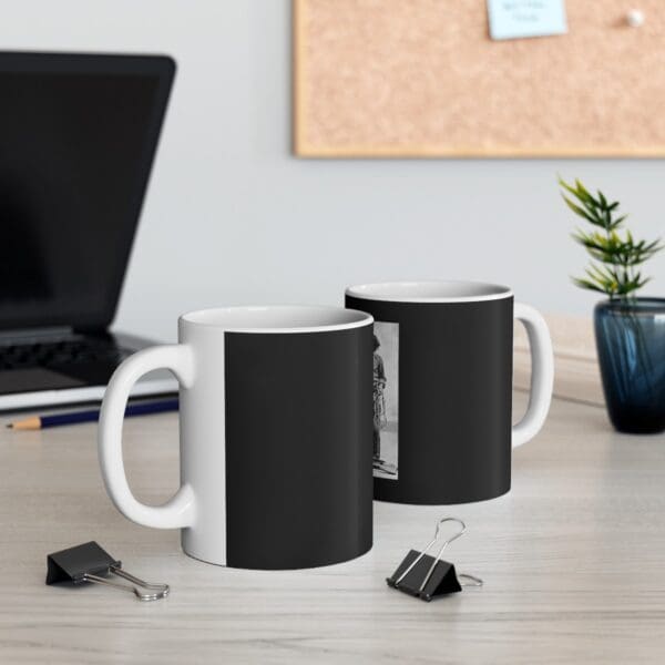 Two white mugs with black designs.