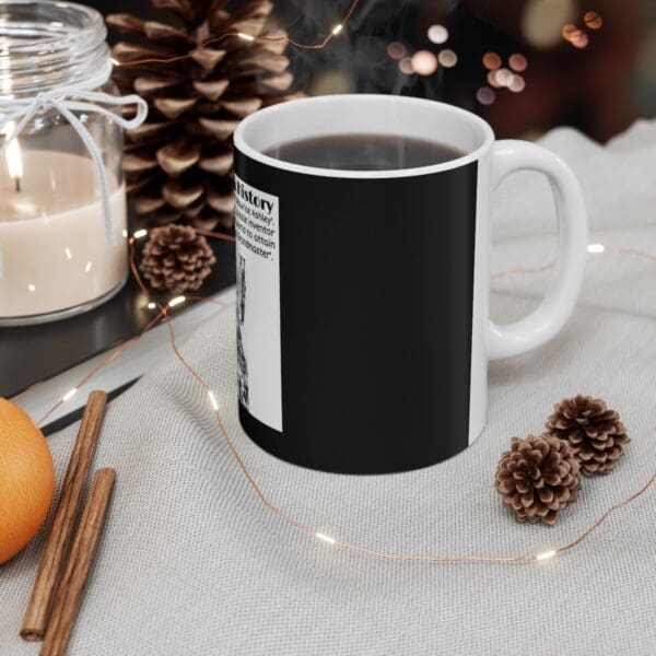 Black coffee mug with white text.