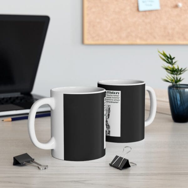 Black mug with white text and image.