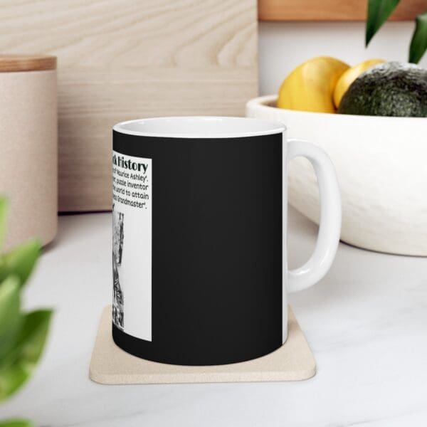 Black coffee mug with a Rubik's Cube image.