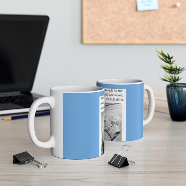 White mug with blue background and text.