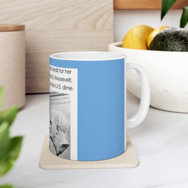 Blue mug with Franklin D. Roosevelt on US dime.