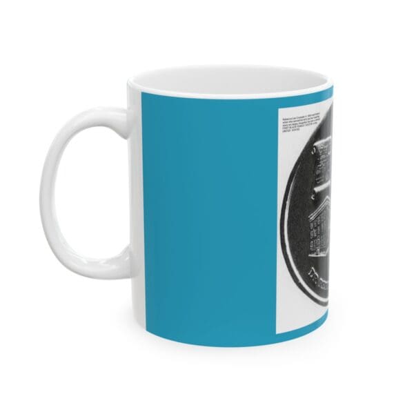 White coffee mug with blue and black design.