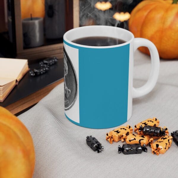 Blue mug with coffee and Halloween candy.