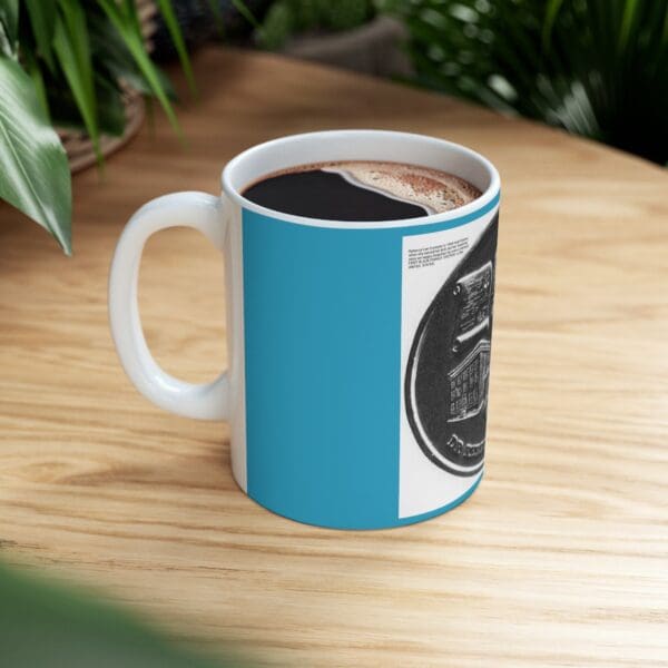 Blue mug with black and white design.