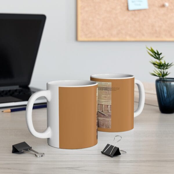 White mug with brown and image of a building.